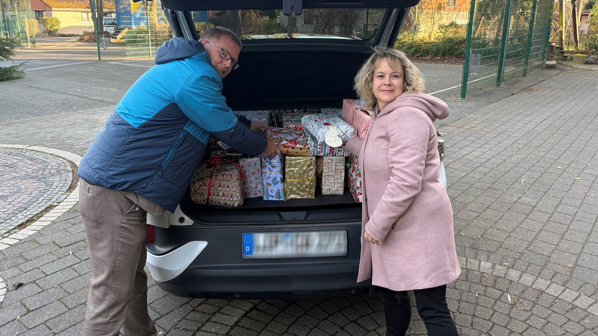 Björn Hartmann, Leiter Personal bei Brasseler, und Tanja Obermeier, Teamassistentin Personal, beim Einladen der Päckchen